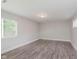 Simple living room featuring lots of natural light and wood-look flooring at 3149 Thayer St, Indianapolis, IN 46222