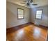 Bright bedroom featuring hardwood floors and natural light from two windows at 336 Brookside Ln, Plainfield, IN 46168