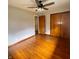 Hardwood flooring and a ceiling fan grace this bedroom with closet at 336 Brookside Ln, Plainfield, IN 46168