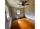 This bedroom features hardwood flooring, neutral paint, and a ceiling fan with an integrated light kit at 336 Brookside Ln, Plainfield, IN 46168