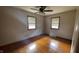Bright bedroom featuring hardwood floors and natural light from two windows at 336 Brookside Ln, Plainfield, IN 46168