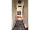 Hallway leading to kitchen with hardwood floors and neutral paint at 336 Brookside Ln, Plainfield, IN 46168