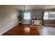 A view of an open concept room featuring hardwood floors, gray walls, and plenty of light at 336 Brookside Ln, Plainfield, IN 46168