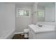 Bright bathroom featuring a large mirror, white vanity, and combination tub and shower at 3538 N Elizabeth St, Indianapolis, IN 46226