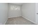 Empty bedroom with neutral walls, carpeted flooring, and a window at 3538 N Elizabeth St, Indianapolis, IN 46226