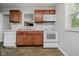 Functional kitchen with white appliances, wooden cabinets, and laminate flooring at 3538 N Elizabeth St, Indianapolis, IN 46226