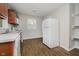 Well-lit kitchen with updated cabinets, white appliances, and wood-look vinyl flooring at 3538 N Elizabeth St, Indianapolis, IN 46226