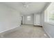 Open-concept living area with neutral carpet, fan, and an entry door at 3538 N Elizabeth St, Indianapolis, IN 46226