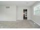 Living room with neutral walls and carpet, window, and view of kitchen at 3538 N Elizabeth St, Indianapolis, IN 46226