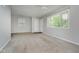 Open living room features neutral carpet, a ceiling fan, and natural light at 3538 N Elizabeth St, Indianapolis, IN 46226