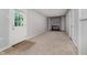 Cozy living room with stone fireplace, neutral walls, a door to the exterior, and carpeted flooring at 3538 N Elizabeth St, Indianapolis, IN 46226