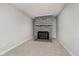 Living room with a stone fireplace, neutral walls, and carpeted flooring at 3538 N Elizabeth St, Indianapolis, IN 46226