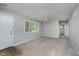 Bright, freshly painted living room featuring neutral carpet, ceiling fan, and natural light at 3538 N Elizabeth St, Indianapolis, IN 46226