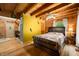 Inviting bedroom with wood walls, a queen-sized bed, and access to another living space at 3715 Orchard Rd, Columbus, IN 47201