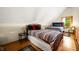 Comfortable bedroom with two beds, wooden floors, and natural light from the window at 3715 Orchard Rd, Columbus, IN 47201