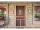 Charming front porch with a screen door, cozy seating, and welcoming decor that says, 