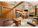 Warm living area featuring wood finishes, a stone fireplace, kitchen, and a cozy loft above at 3715 Orchard Rd, Columbus, IN 47201