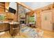 Interior view of a wooden cabin with stone fireplace, modern kitchen, and bright natural light at 3715 Orchard Rd, Columbus, IN 47201