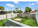 A fenced backyard is shown from the home's deck with limited landscaping visible at 410 Montgomery St, Shelbyville, IN 46176