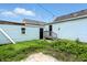 Image of the backyard of the home, featuring a grassy area and blue siding on the exterior at 410 Montgomery St, Shelbyville, IN 46176