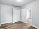 Bedroom featuring modern vinyl flooring and neutral paint, with ample closet space visible at 410 Montgomery St, Shelbyville, IN 46176