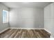 Bright, neutral bedroom showcasing updated flooring and fresh paint, and natural light at 410 Montgomery St, Shelbyville, IN 46176