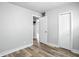 Bedroom featuring modern vinyl flooring and neutral paint, with ample closet space visible at 410 Montgomery St, Shelbyville, IN 46176