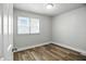 Bright, neutral bedroom showcasing updated flooring, fresh paint, and a window at 410 Montgomery St, Shelbyville, IN 46176