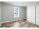 Bright bedroom with a closet, wood-look flooring, and a window letting in natural light at 410 Montgomery St, Shelbyville, IN 46176