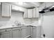 A kitchen area featuring modern grey cabinets, a dual basin sink and stainless-steel fixtures at 410 Montgomery St, Shelbyville, IN 46176