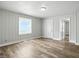 Naturally lit living room, featuring paneled walls and wood-look floors at 410 Montgomery St, Shelbyville, IN 46176