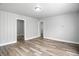 Bright, neutral living room featuring wood-look floors and panelling for a modern appeal at 410 Montgomery St, Shelbyville, IN 46176