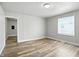 Bright, neutral living room featuring wood-look floors and panelling for a modern appeal at 410 Montgomery St, Shelbyville, IN 46176