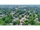 A lush neighborhood filled with trees, cozy homes, winding streets, and a marked location at 4129 Cornelius Ave, Indianapolis, IN 46208