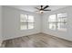 Bright bedroom features two windows, modern ceiling fan, and wood-look flooring at 4129 Cornelius Ave, Indianapolis, IN 46208
