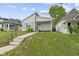 Charming gray home with a neatly maintained lawn, a concrete pathway, and front yard landscaping at 4129 Cornelius Ave, Indianapolis, IN 46208