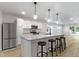 Open kitchen featuring granite countertops, island with bar seating, and stainless steel appliances at 4129 Cornelius Ave, Indianapolis, IN 46208