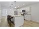 Open kitchen featuring granite countertops, an island with seating, and stainless steel appliances at 4129 Cornelius Ave, Indianapolis, IN 46208