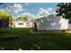 View of the home's backyard with a garage, trampoline, and a deck with outdoor furniture off the back of the home at 431 N Bauman St, Indianapolis, IN 46214