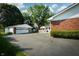A view of the backyard shows a detached garage and a deck with patio furniture off the back of the home at 431 N Bauman St, Indianapolis, IN 46214