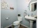 Powder room with a pedestal sink and ornate decor at 431 N Bauman St, Indianapolis, IN 46214