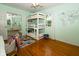 Bright bedroom featuring a unique triple bunk bed, hardwood floors, and a mirrored closet for added storage at 431 N Bauman St, Indianapolis, IN 46214