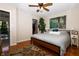 Bedroom features a large bed, hardwood floors, and a view into the hallway at 431 N Bauman St, Indianapolis, IN 46214