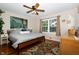 Cozy bedroom with ceiling fan, wood floors, and a queen sized bed at 431 N Bauman St, Indianapolis, IN 46214