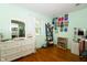 Bedroom with hardwood floors, white dresser, and ample closet space at 431 N Bauman St, Indianapolis, IN 46214