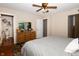 Bedroom with hardwood floors, ceiling fan, and en suite bathroom at 431 N Bauman St, Indianapolis, IN 46214