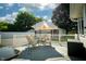 Deck with outdoor chairs and umbrella with view of the detached garage at 431 N Bauman St, Indianapolis, IN 46214