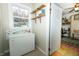 Hallway with storage cabinet that leads to a room with bookshelves and desk at 431 N Bauman St, Indianapolis, IN 46214