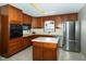 Kitchen with stainless steel appliances, tile flooring, and lots of wood cabinets at 431 N Bauman St, Indianapolis, IN 46214