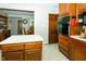 Open kitchen with wooden cabinets, oven, and a view into a dining area at 431 N Bauman St, Indianapolis, IN 46214